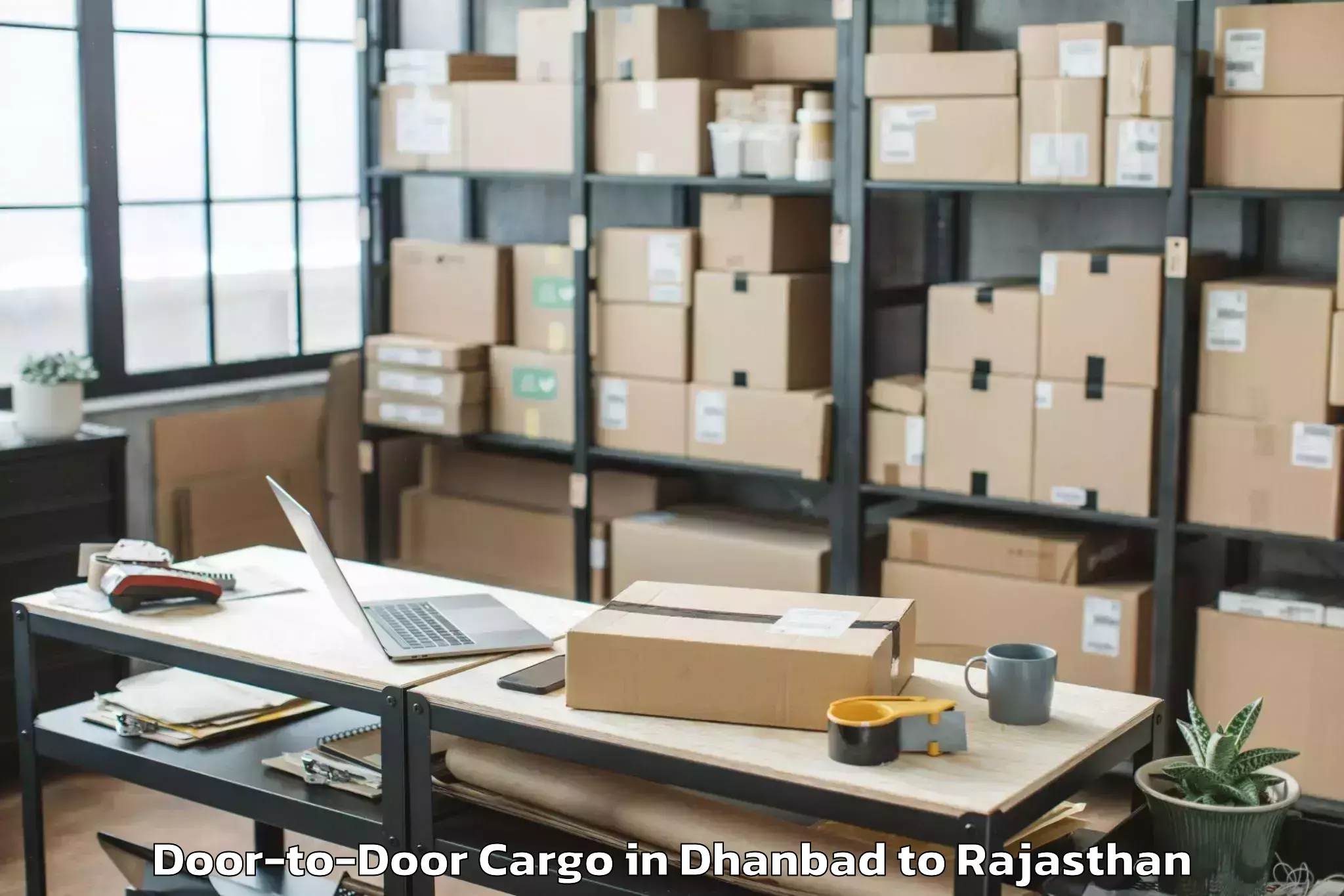 Efficient Dhanbad to Mewar University Chittorgarh Door To Door Cargo